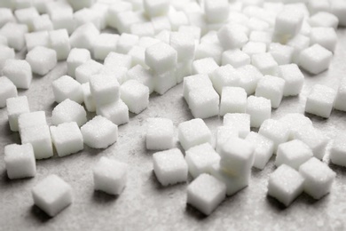 Refined sugar cubes on grey background