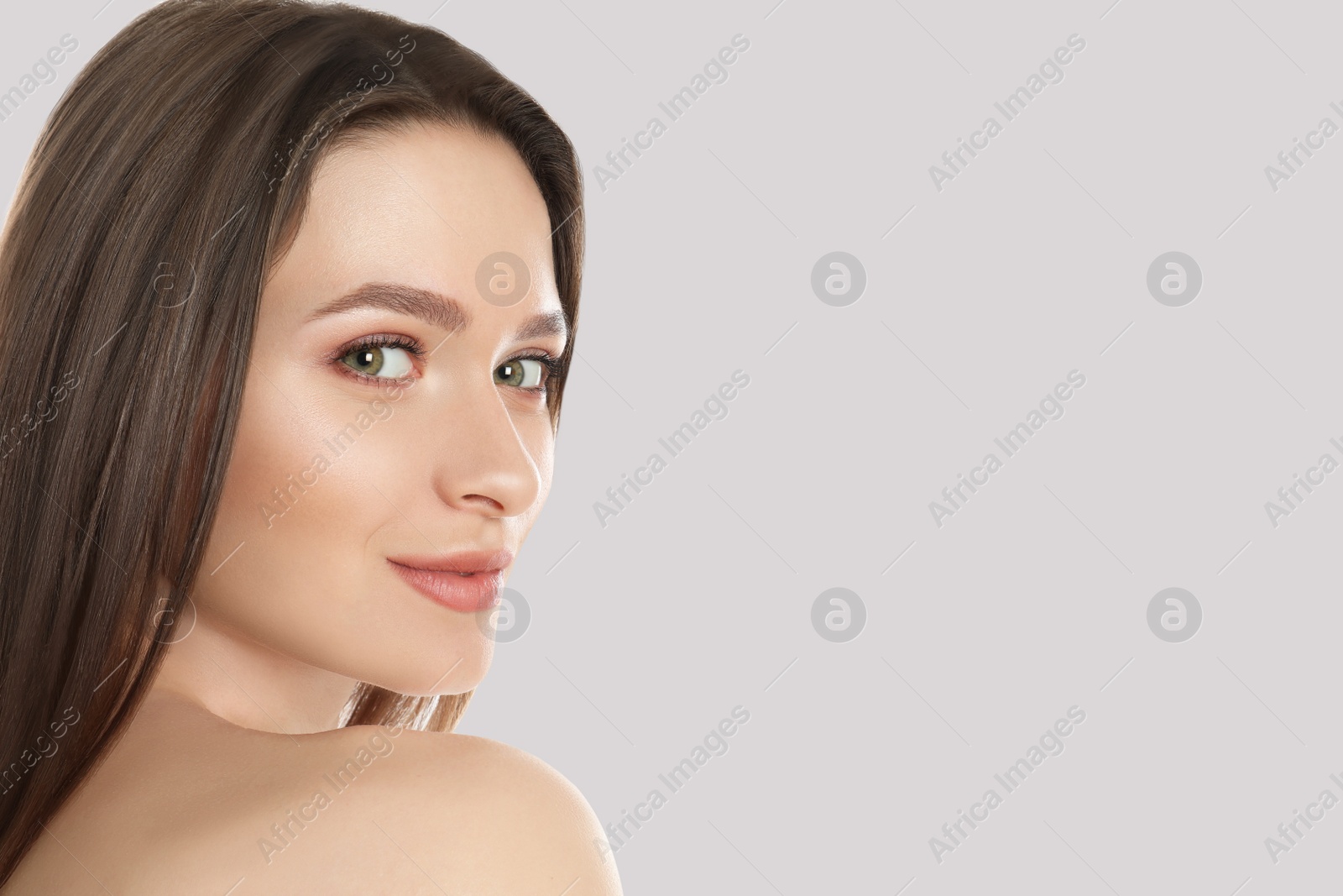 Image of Young woman with beautiful face on light background, space for text 