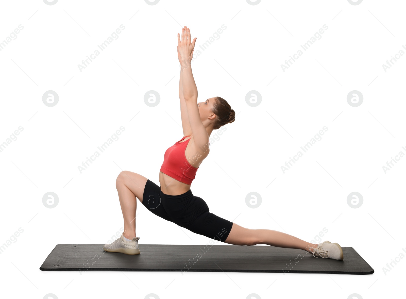 Photo of Yoga workout. Young woman stretching on white background