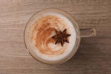 Photo of Delicious eggnog with anise on wooden table, top view
