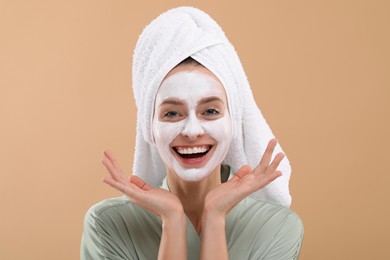 Photo of Woman with face mask on beige background. Spa treatments