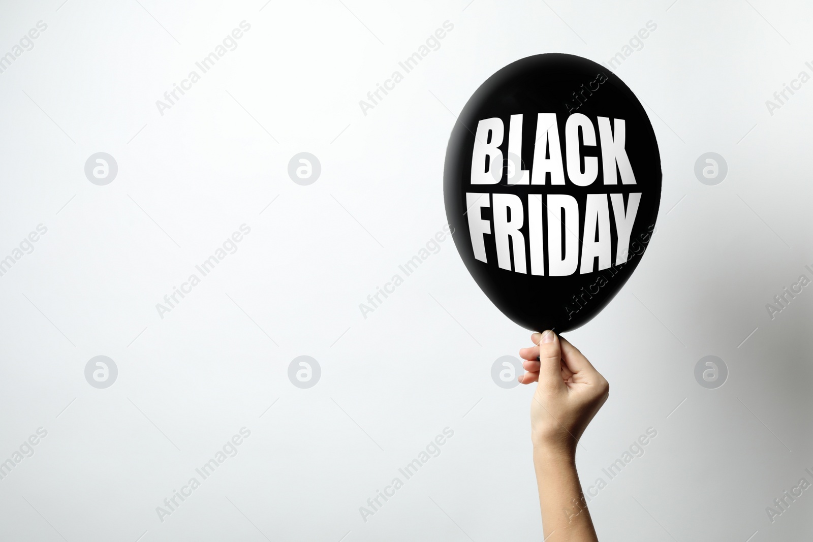 Image of Woman holding balloon with phrase BLACK FRIDAY on white background, space for text