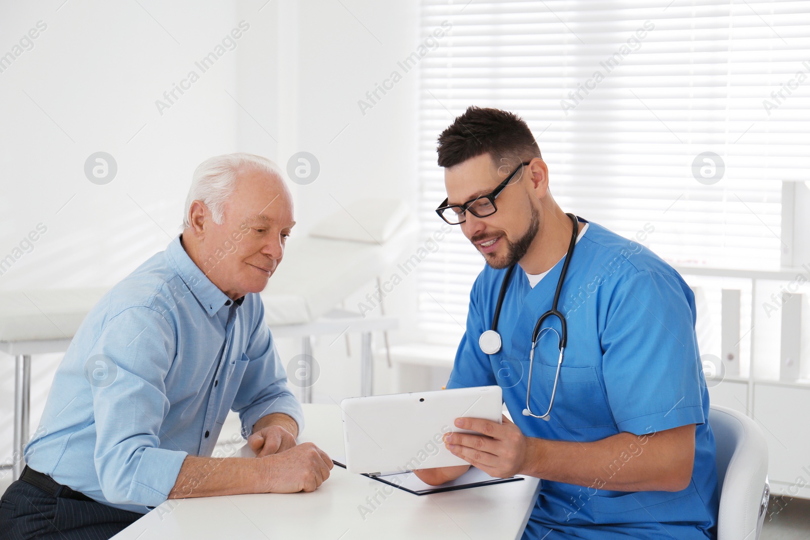 Photo of Senior man visiting doctor in modern office