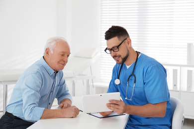 Senior man visiting doctor in modern office