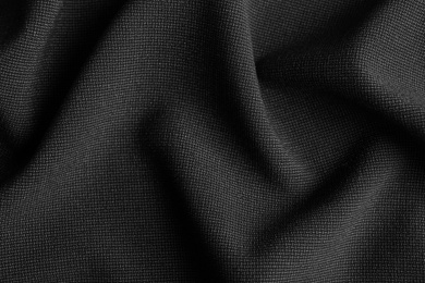 Photo of Texture of dark fabric as background, closeup