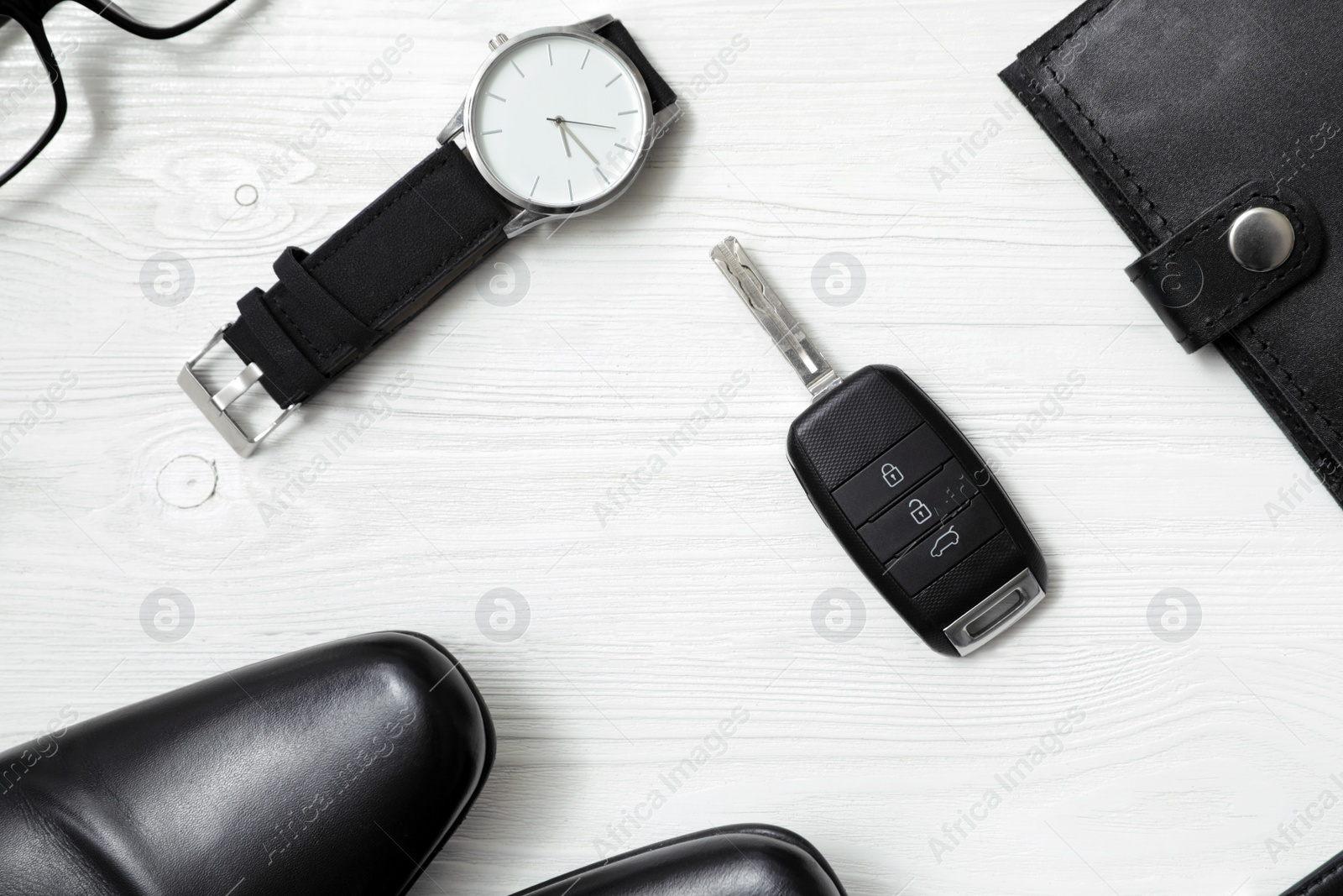 Photo of Flat lay composition with male accessories and car key on white wooden background