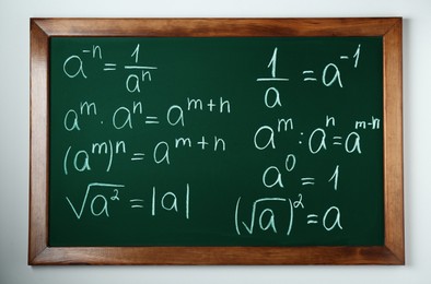 Photo of Chalkboard with many different math formulas on white wall