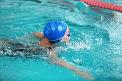 Photo of Young athletic woman swimming in pool