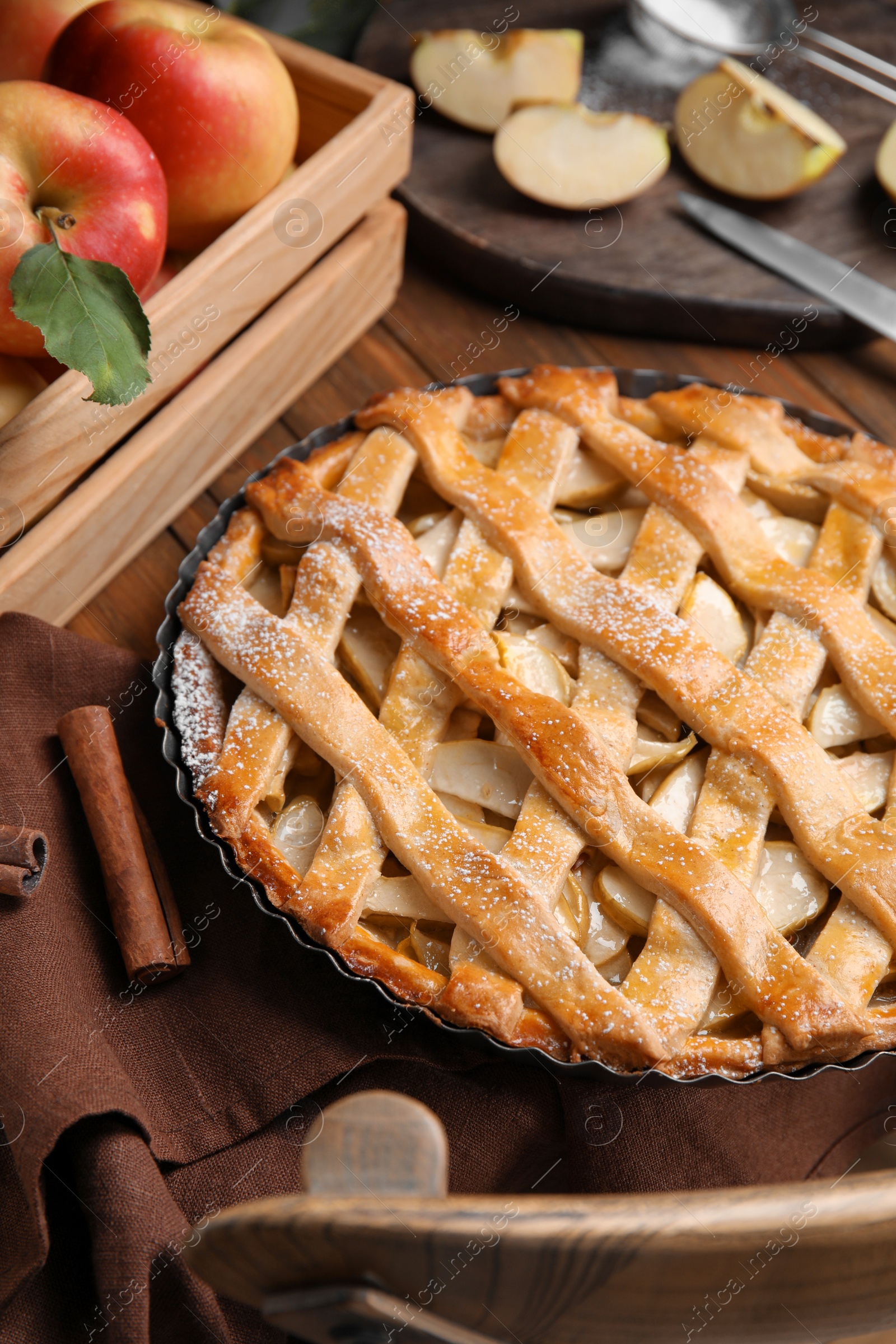 Photo of Delicious traditional apple pie on wooden table