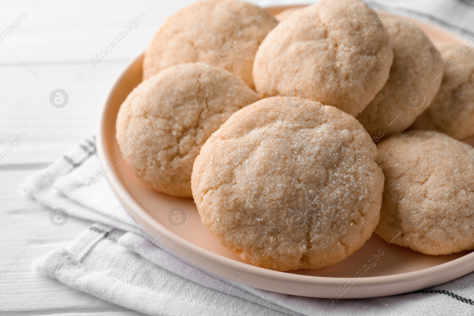 Photo of Delicious sugar cookies on white wooden table, closeup