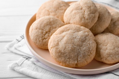 Photo of Delicious sugar cookies on white wooden table, closeup