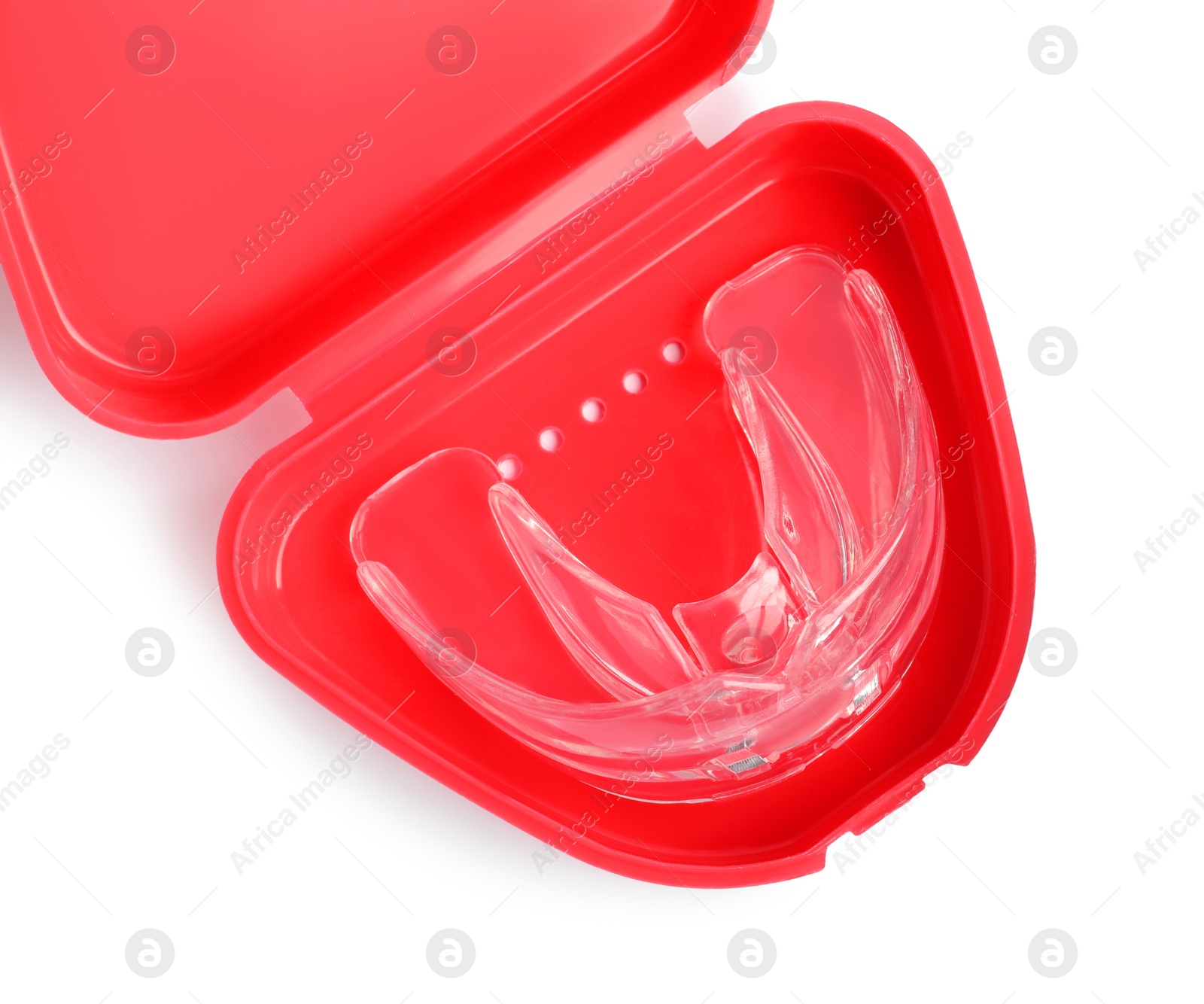 Photo of Transparent dental mouth guard in container isolated on white, top view. Bite correction