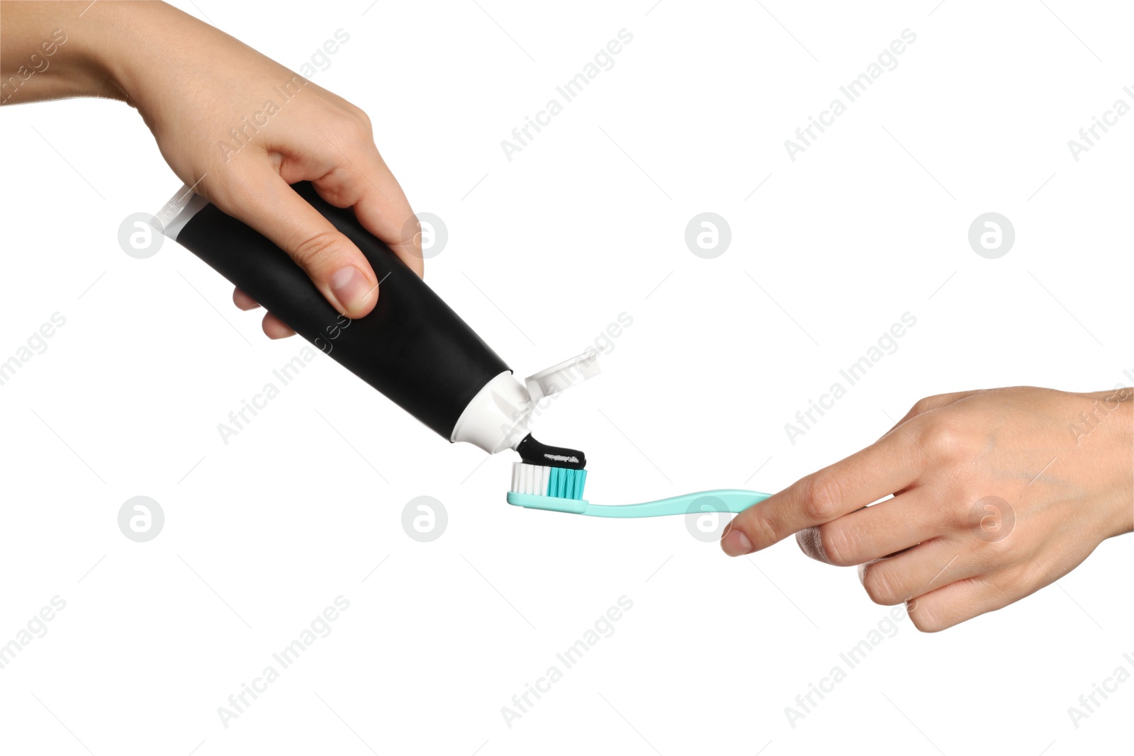 Photo of Woman applying charcoal toothpaste on brush against white background, closeup