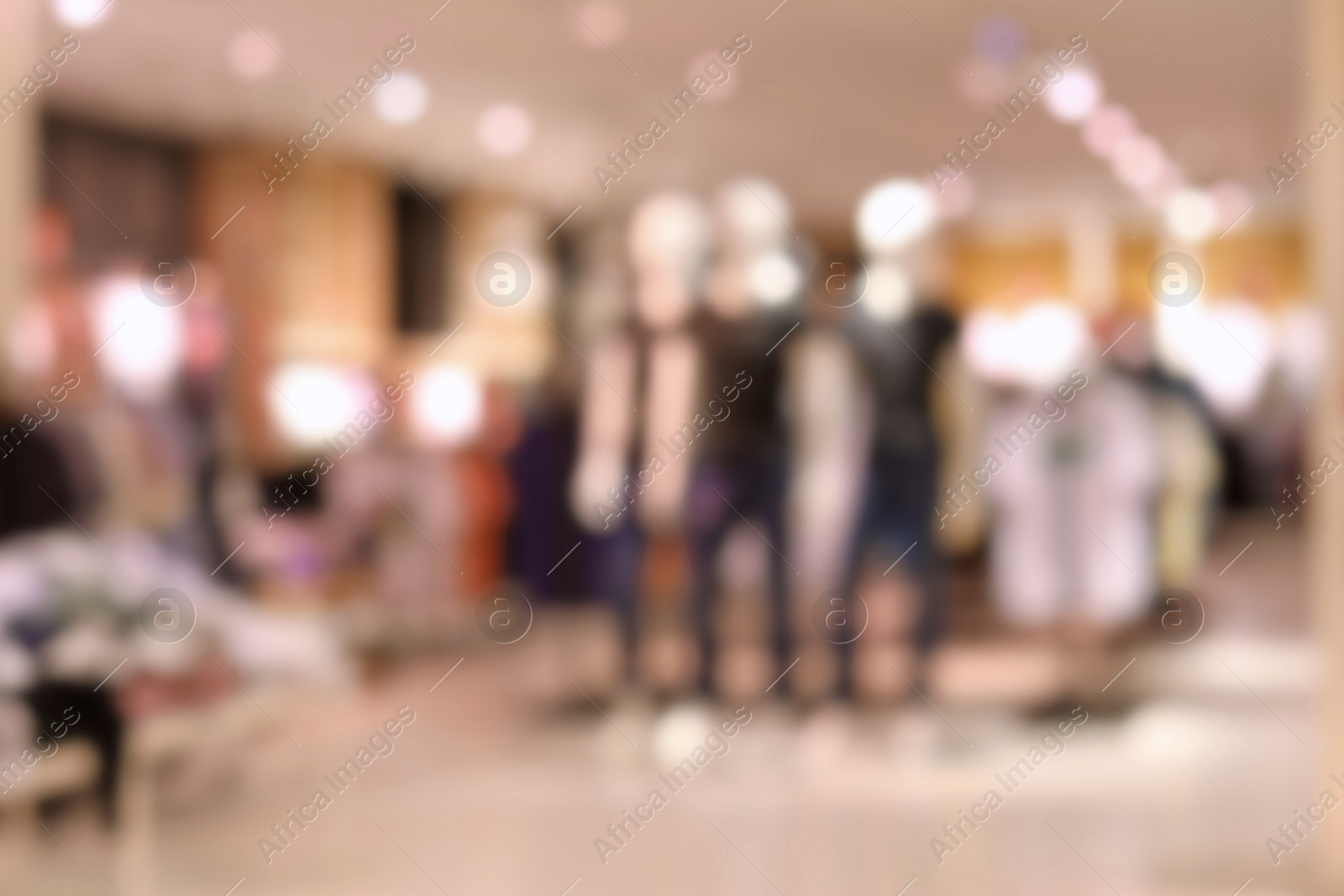 Photo of Blurred view of modern store with different clothes