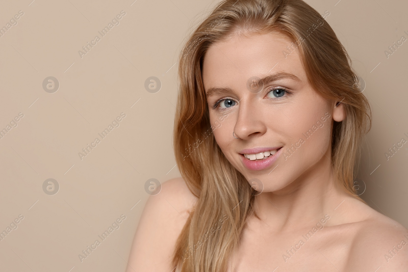 Photo of Portrait of beautiful young woman on beige background. Space for text