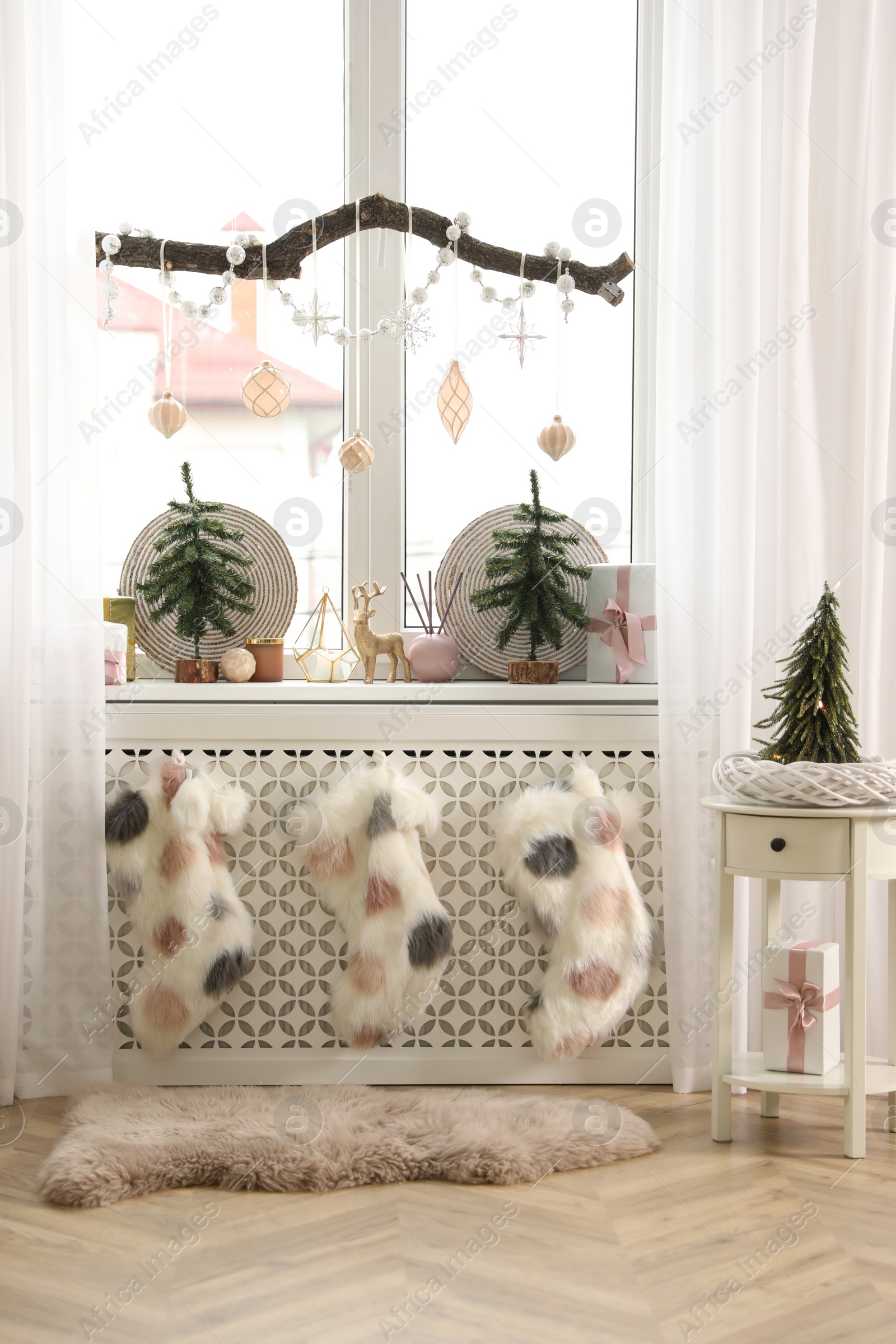 Photo of Beautiful room interior with small fir trees. Christmas decor