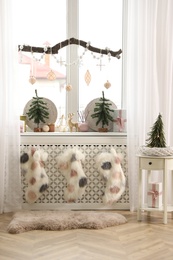 Photo of Beautiful room interior with small fir trees. Christmas decor