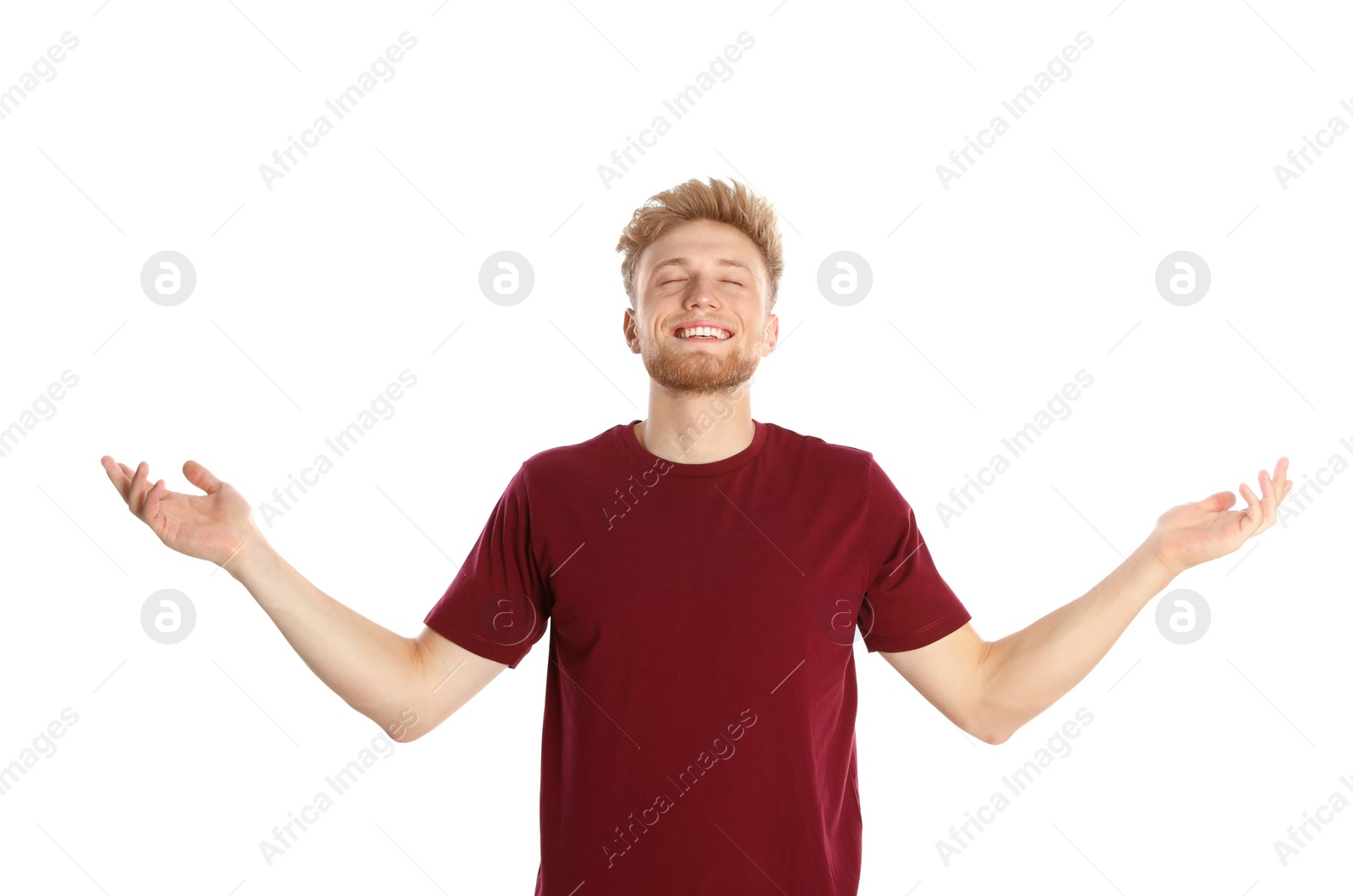 Photo of Young man with air conditioner remote on white background