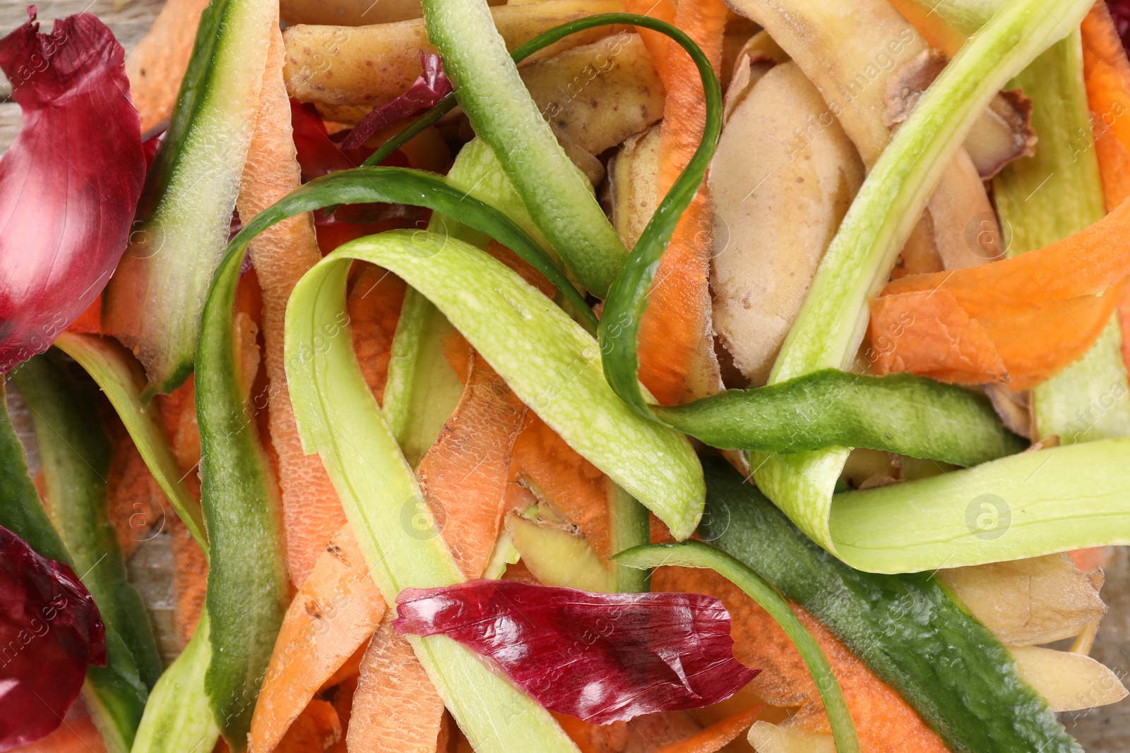 Photo of Peels of fresh vegetables as background, top view