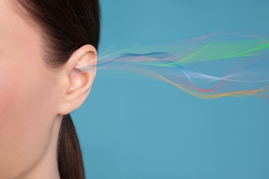 Woman and sound waves illustration on light blue background, closeup. Hearing concept
