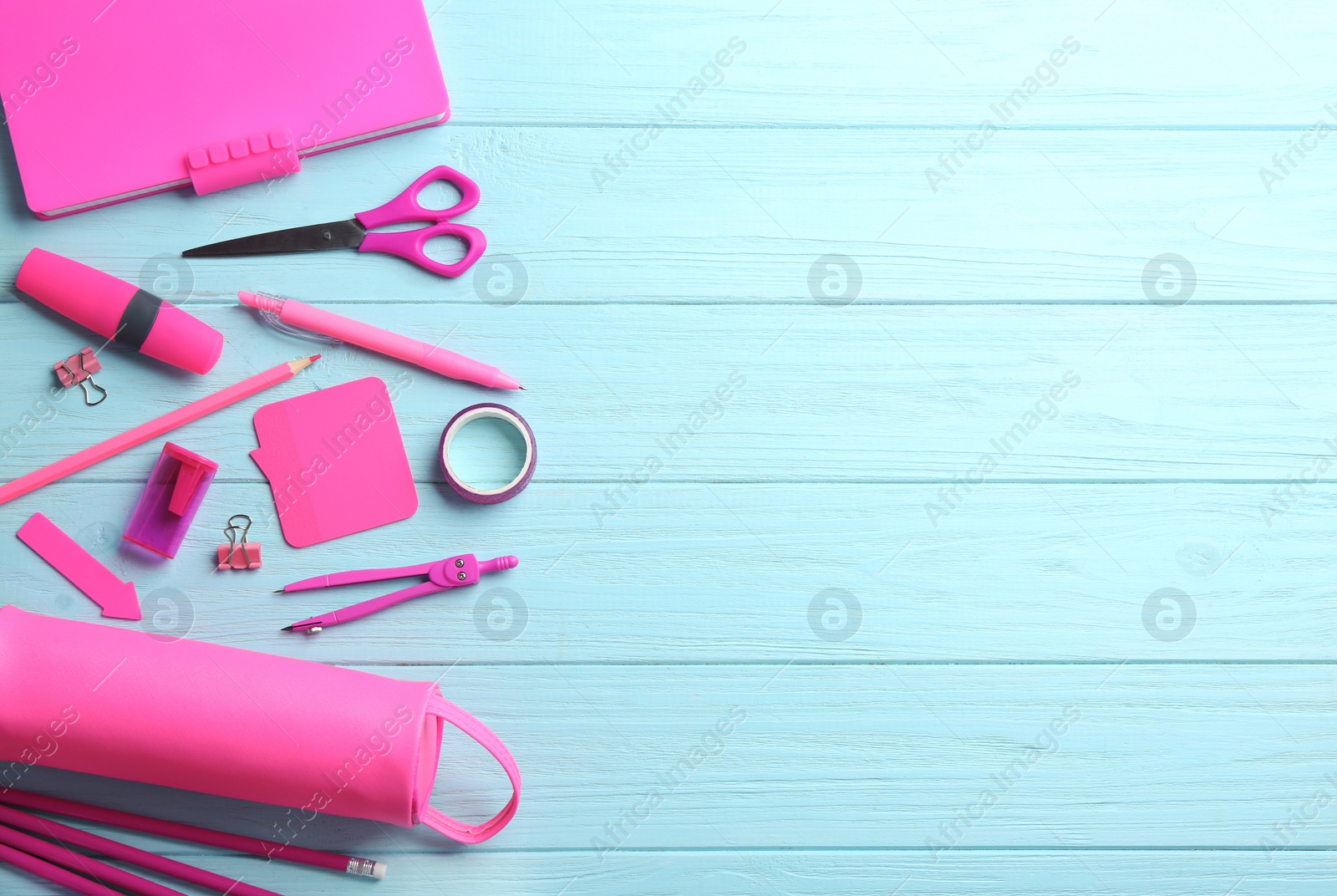 Photo of Different bright school stationery on light blue wooden background, flat lay. Space for text