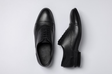 Photo of Pair of leather men shoes on white background, top view