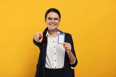 Happy woman with vip pass badge on orange background