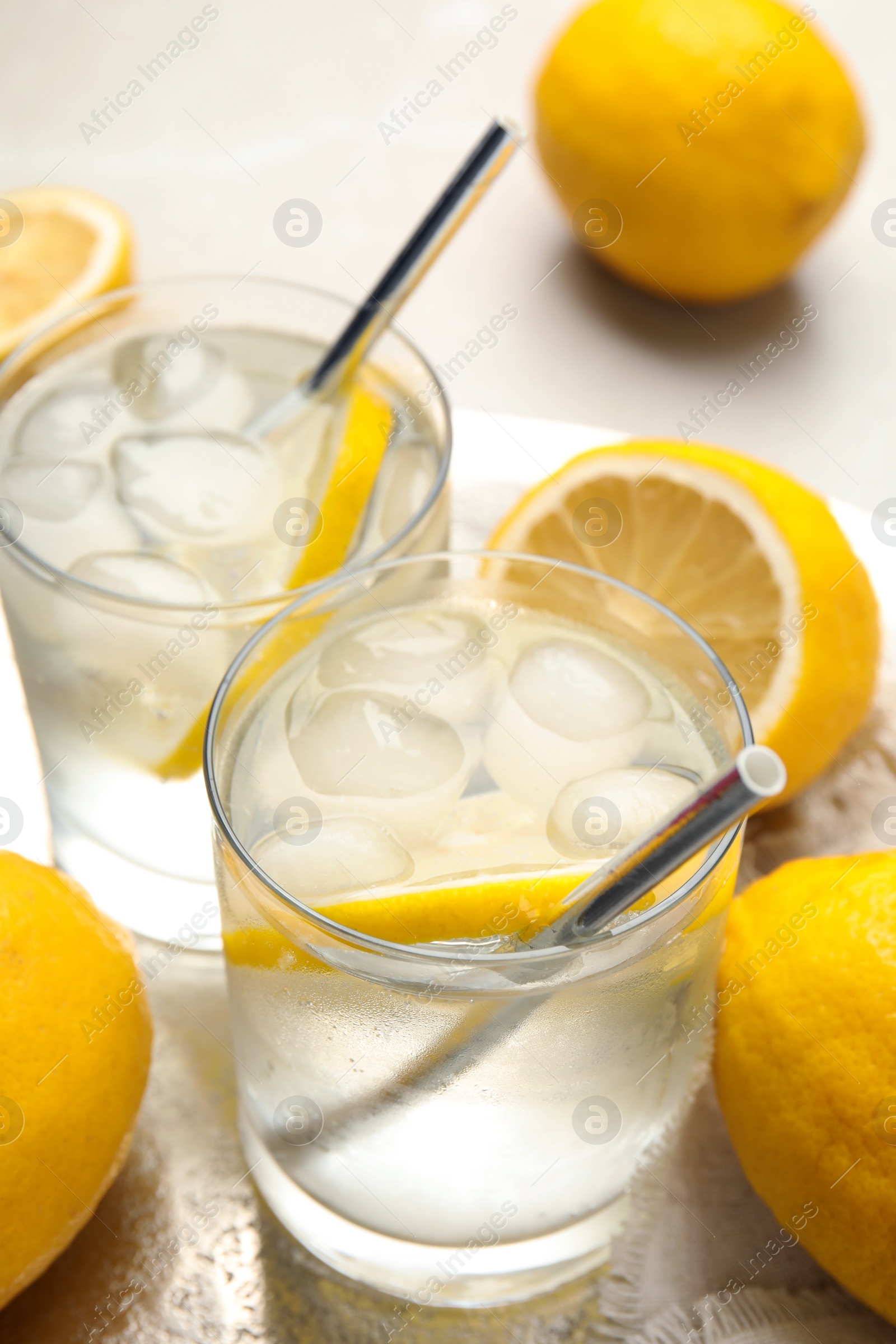 Photo of Soda water with lemon slices and ice cubes on table