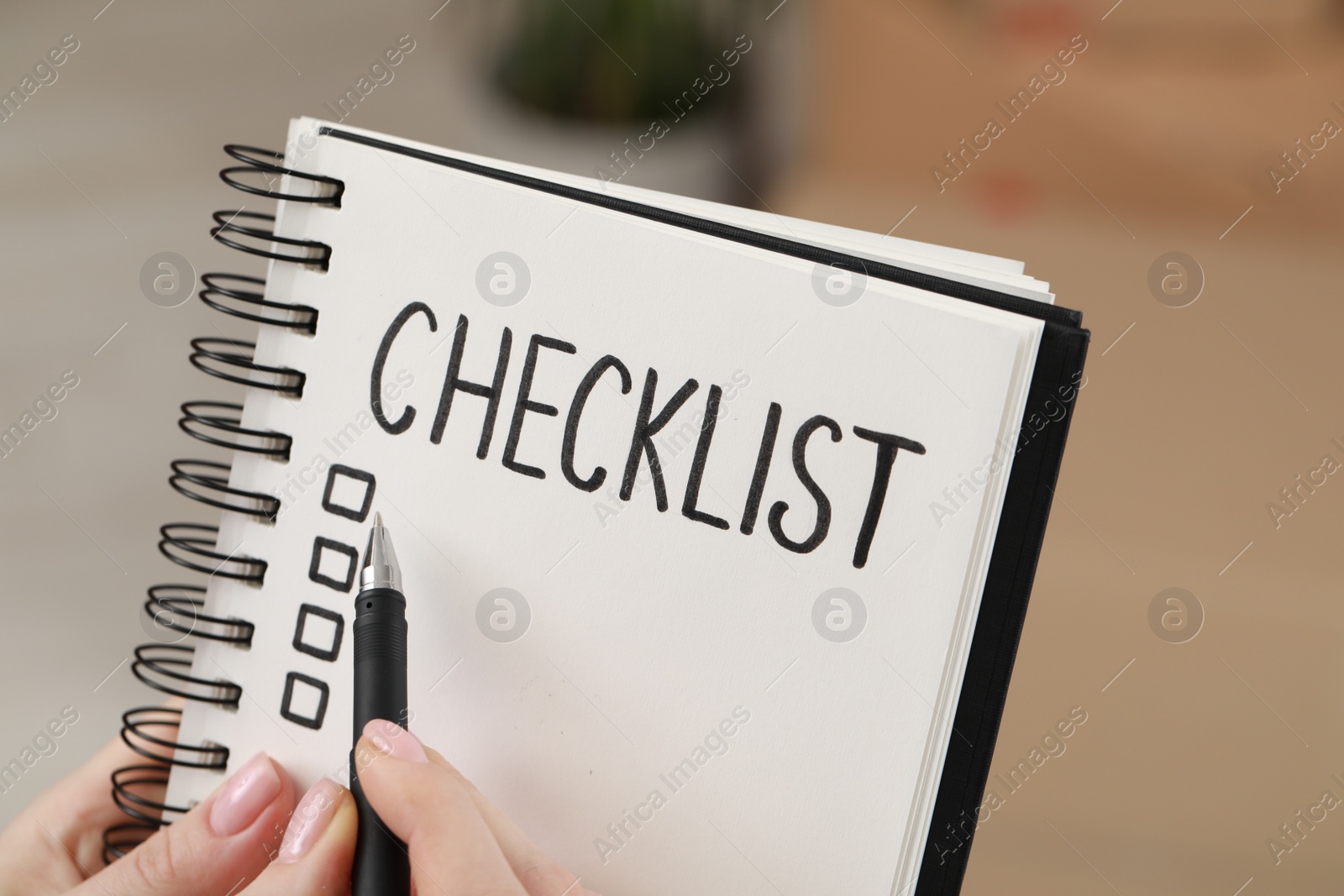 Photo of Woman filling Checklist with pen, closeup view