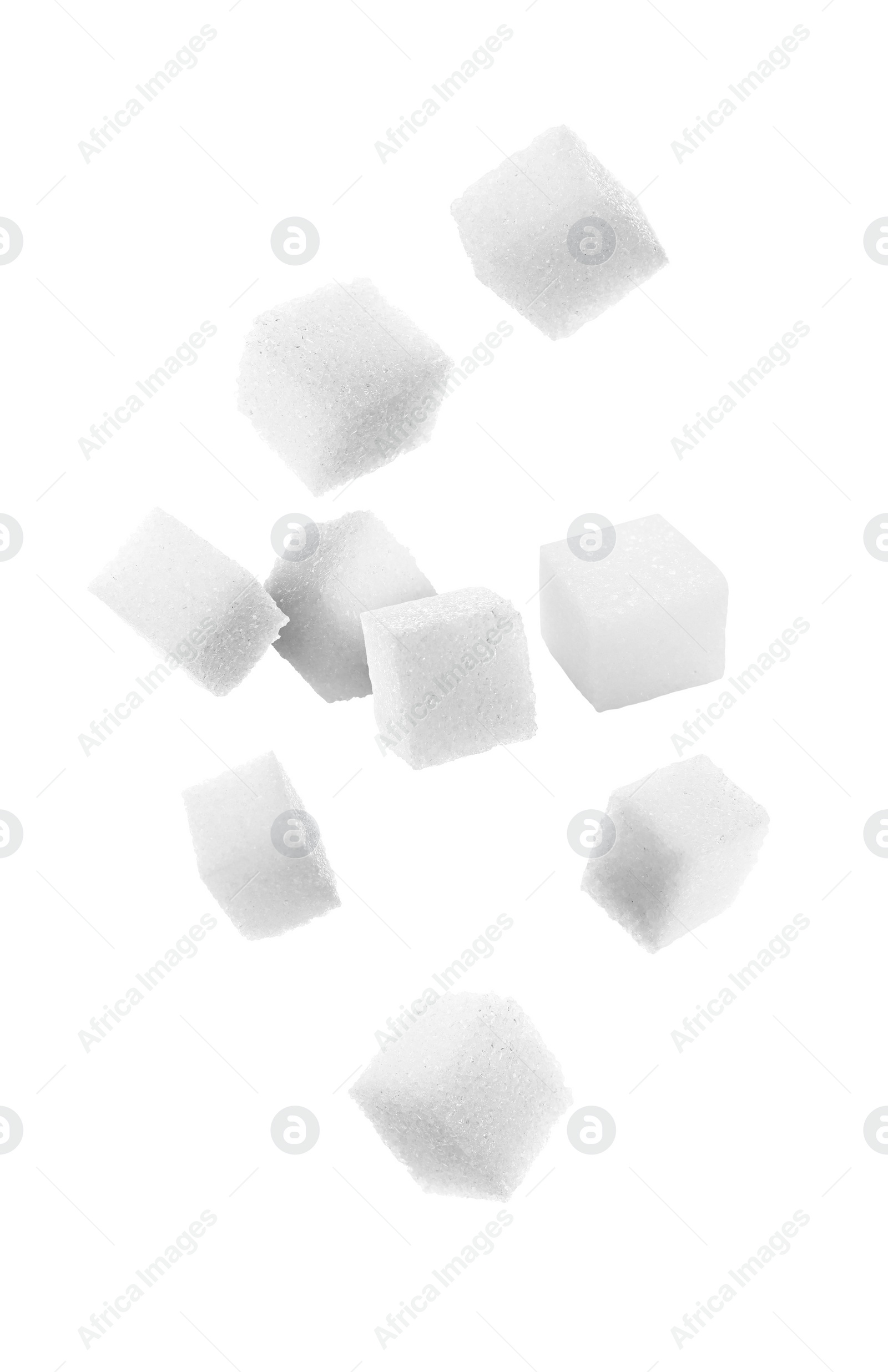 Image of Refined sugar cubes in air on white background