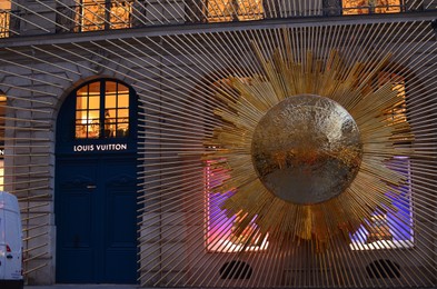 Photo of Paris, France - December 10, 2022: Facade of Louis Vuitton store with beautiful golden decoration