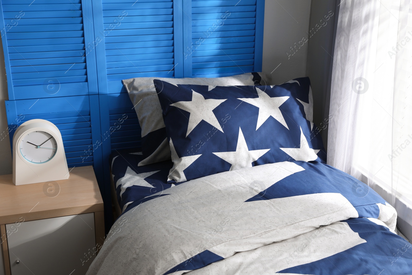 Photo of Bed with stylish linens in children's room