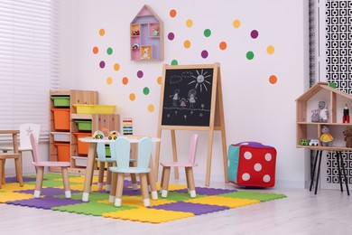 Stylish kindergarten interior with toys and modern furniture