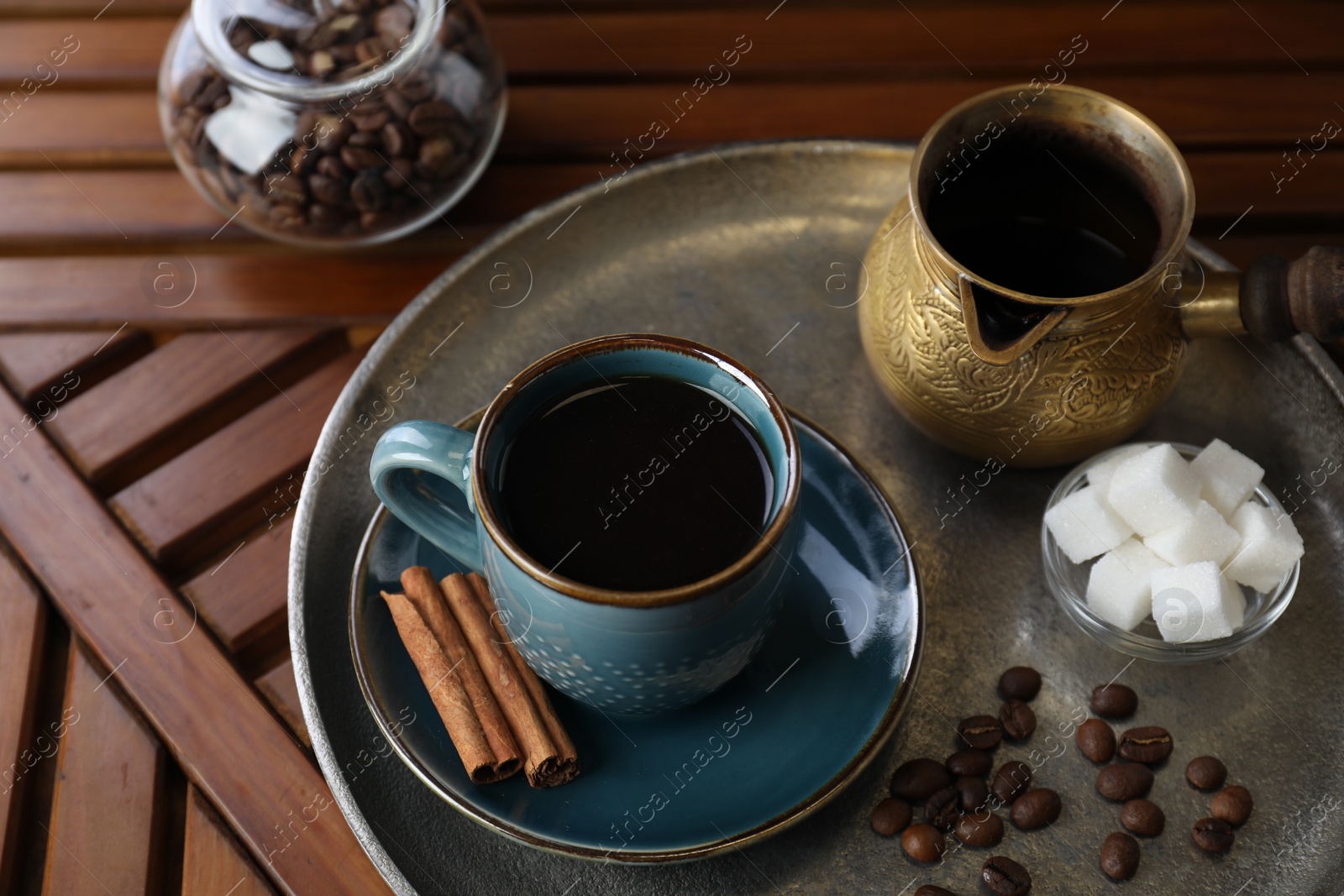 Photo of Turkish coffee. Freshly brewed beverage served on wooden table