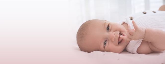 Image of Cute little baby lying on bed at home, closeup view with space for text. Banner design