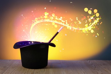 Image of Wizard's hat with wand and magical light on color background