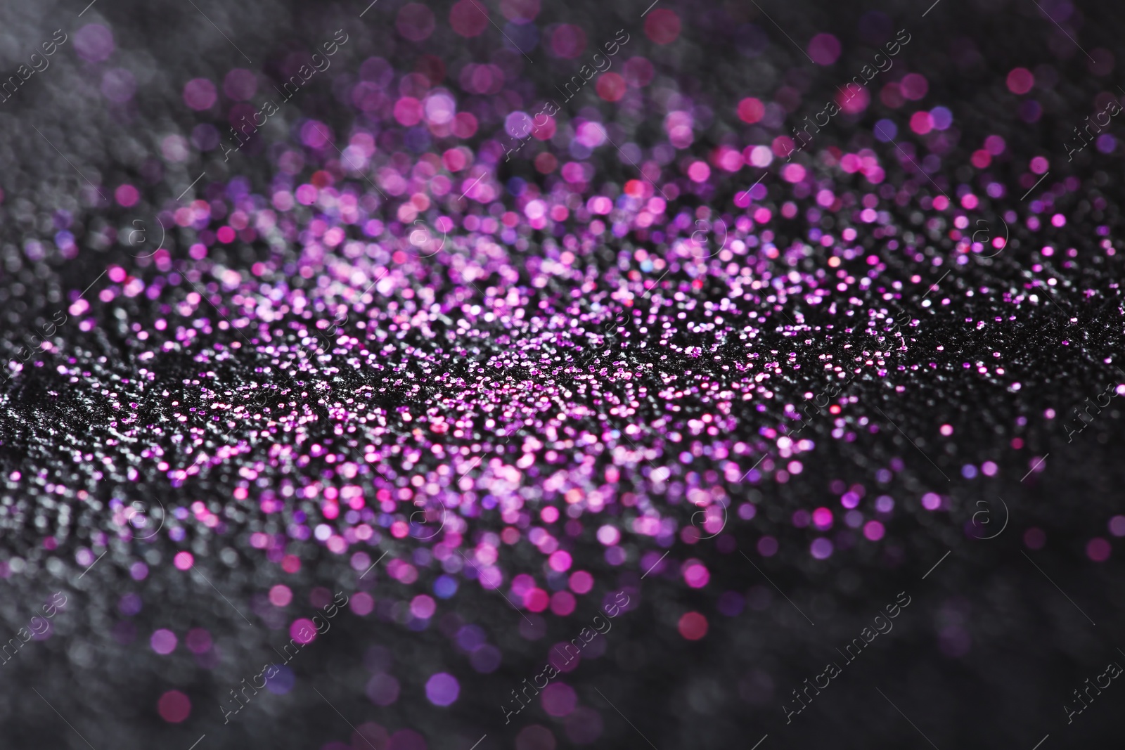 Photo of Pink glitter with bokeh effect on dark background