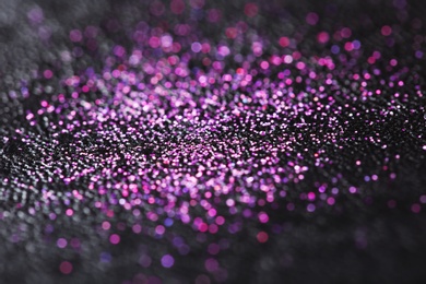 Pink glitter with bokeh effect on dark background