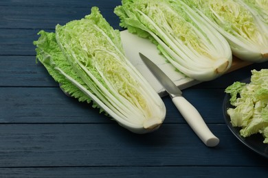 Cut fresh ripe Chinese cabbages on blue wooden table