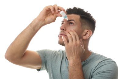 Photo of Man using eye drops on white background