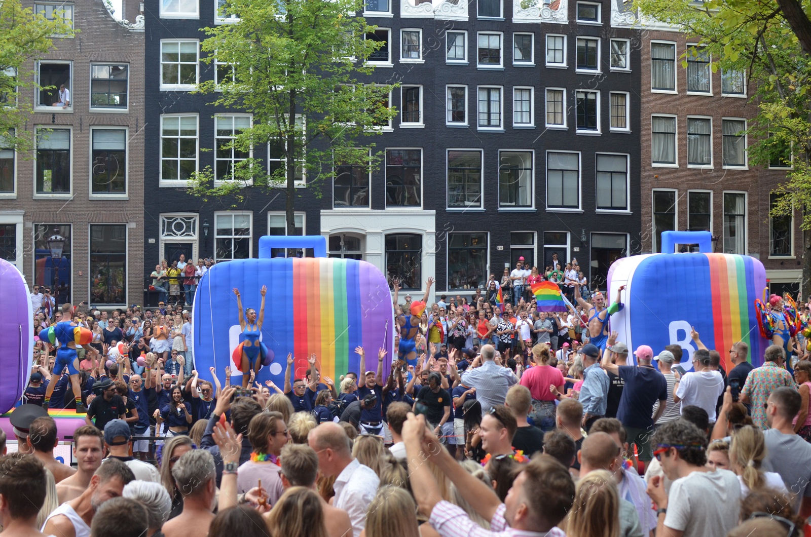 Photo of AMSTERDAM, NETHERLANDS - AUGUST 06, 2022: Many people at LGBT pride parade on summer day