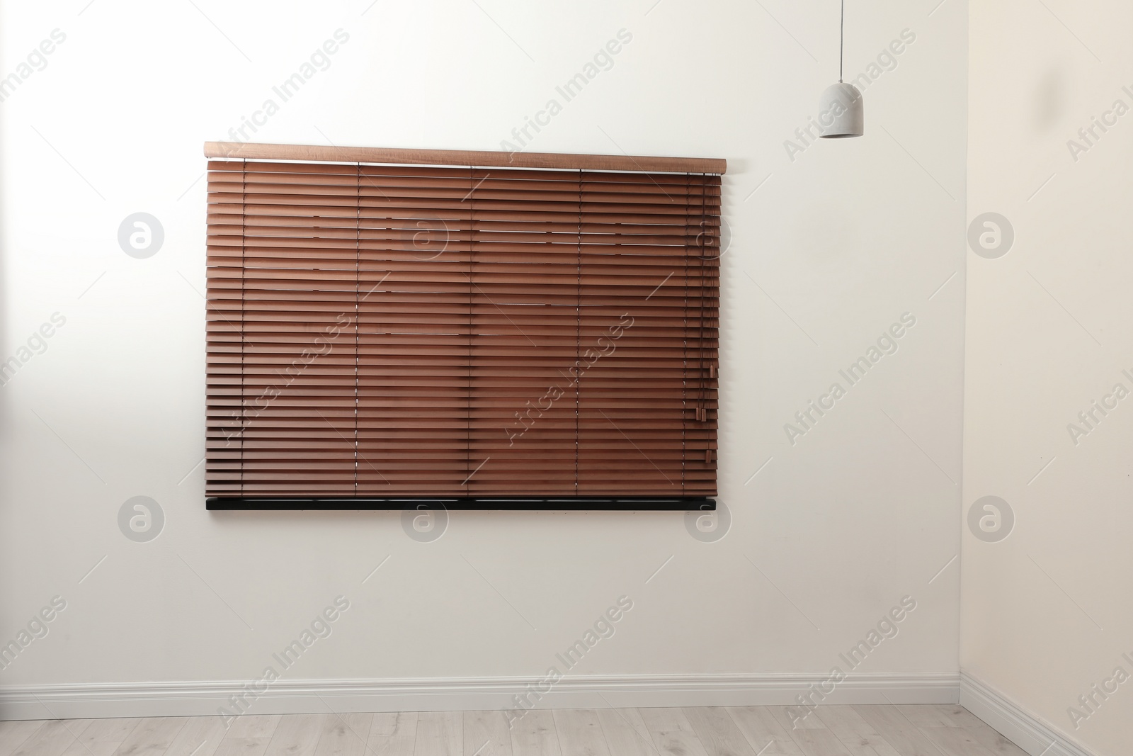 Photo of Modern window with closed stylish wooden blinds indoors. Space for text