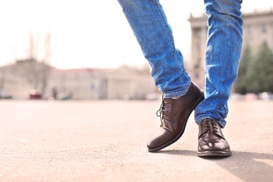 Man in elegant leather shoes outdoors, closeup