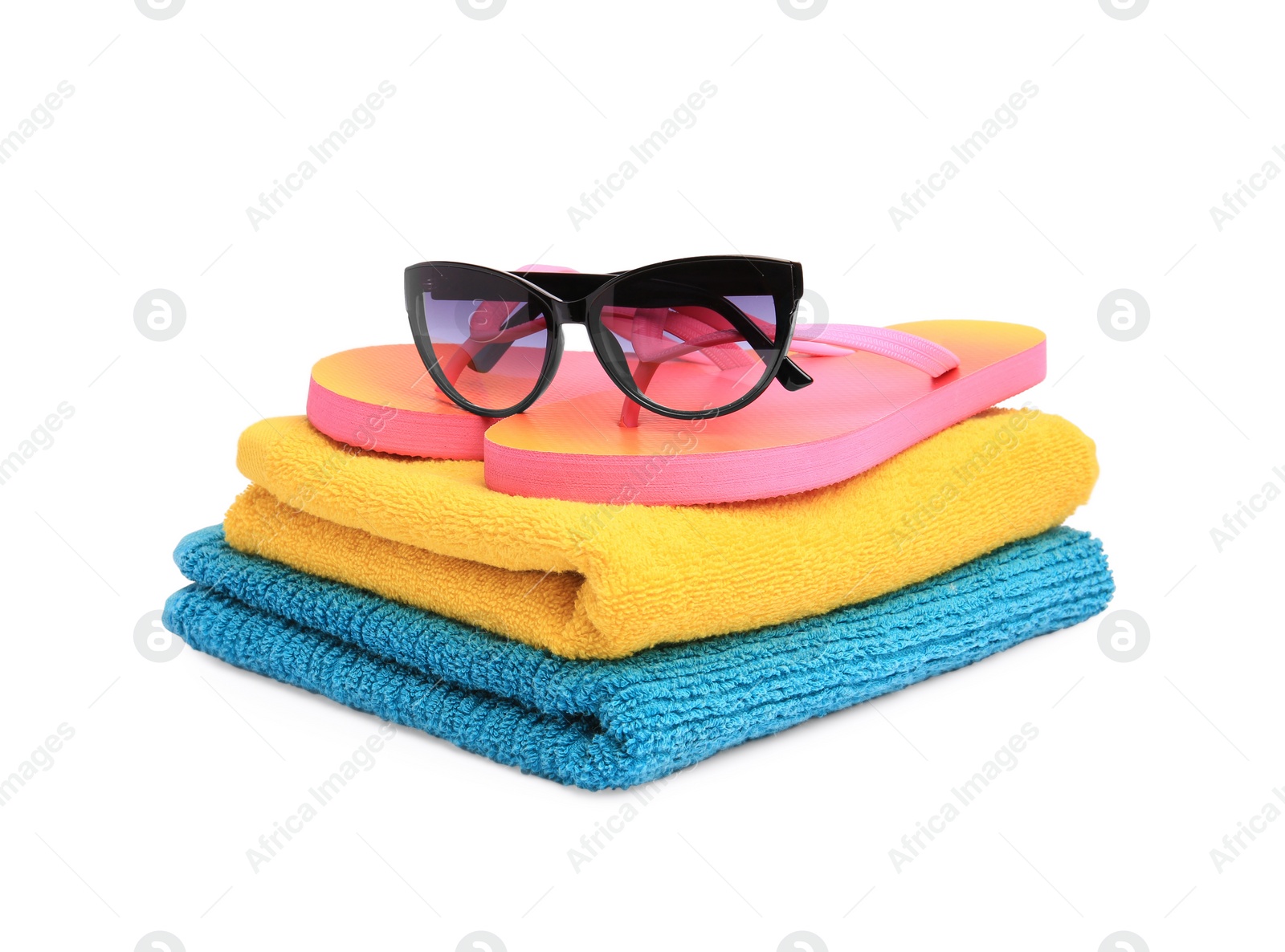 Photo of Colorful terry towels, sunglasses and flip flops isolated on white. Beach objects