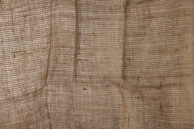 Photo of Texture of natural burlap fabric as background, closeup