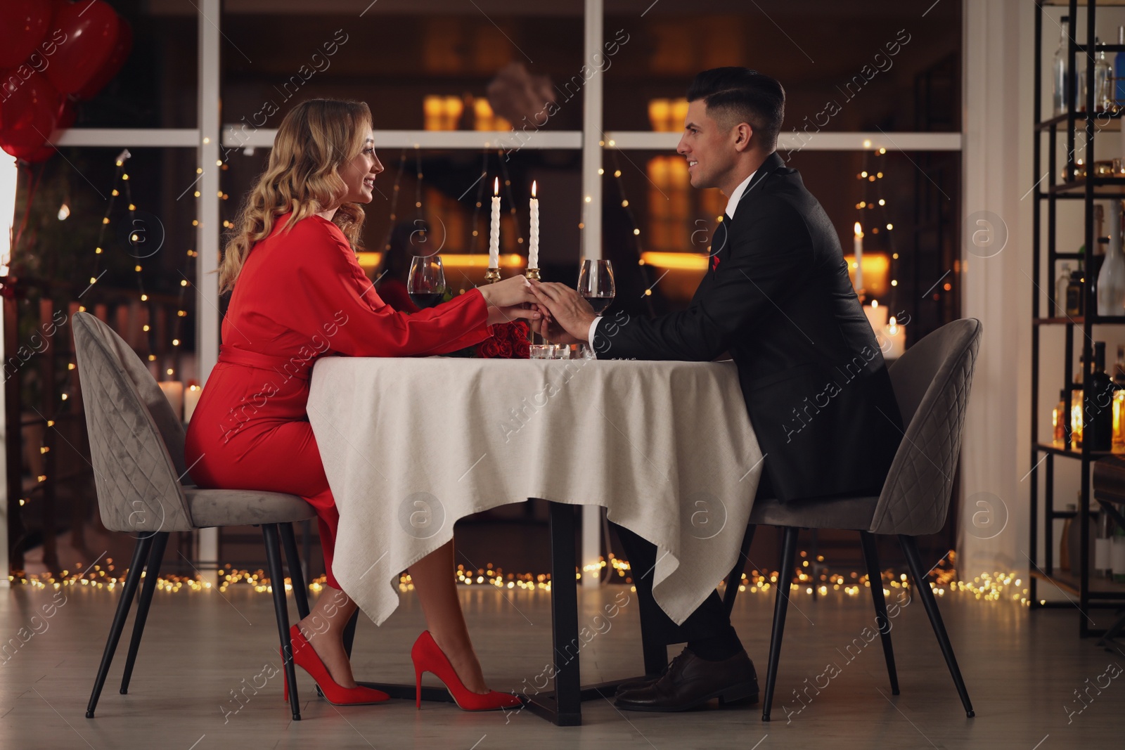 Photo of Lovely couple having romantic dinner on Valentine's day in restaurant