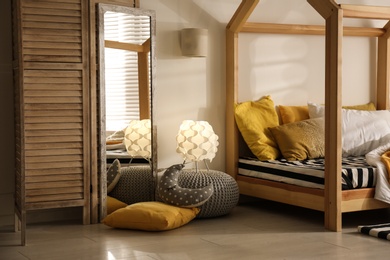 Photo of Cozy child room interior with comfortable bed