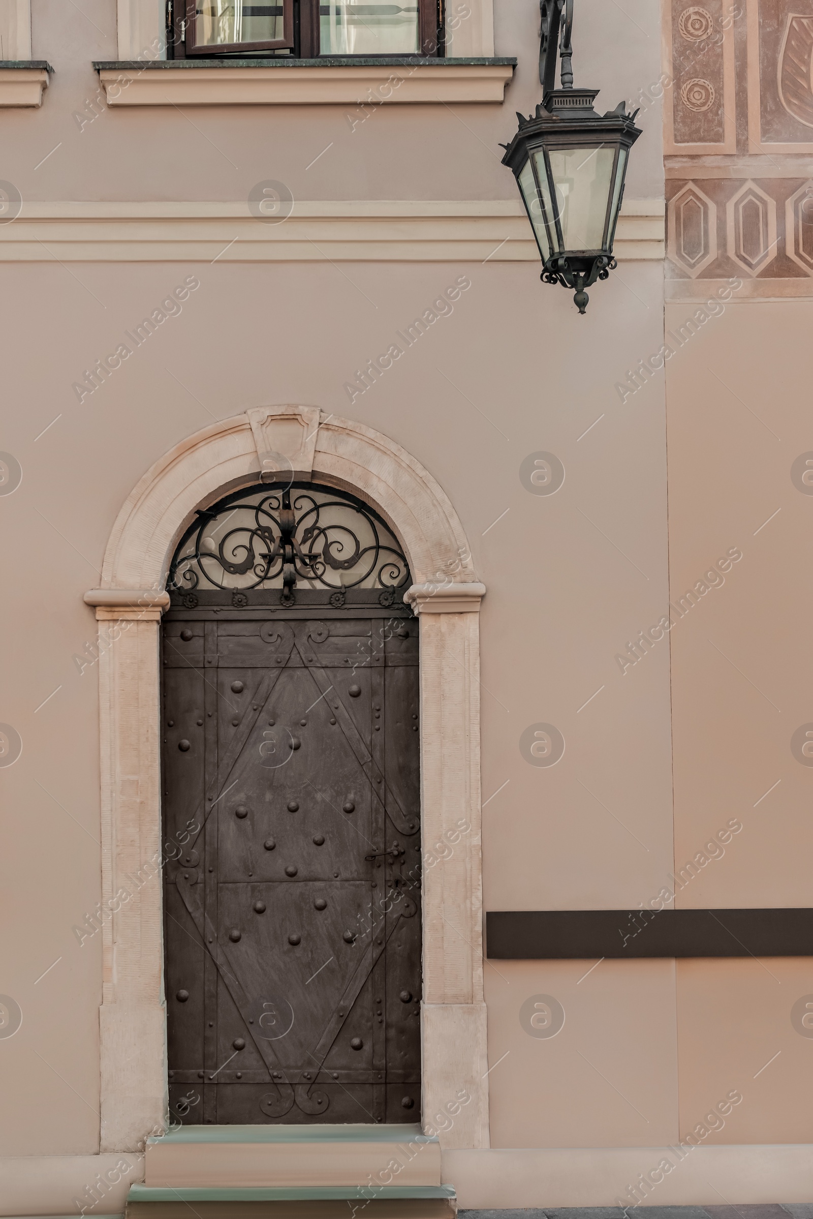 Photo of Entrance of building with grey door and stairs