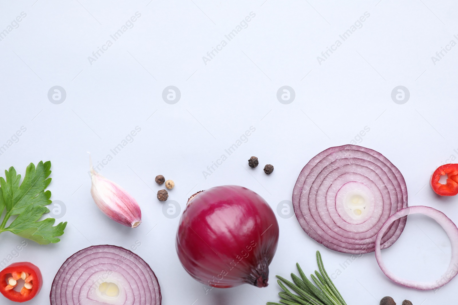 Photo of Flat lay composition with cut onion and spices on light background. Space for text