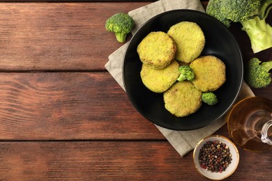 Photo of Tasty vegan cutlets and ingredients on wooden table, flat lay. Space for text